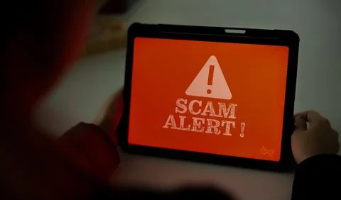 Scam warning screen on tablet screen while using. Concept of security in us.. Stock Photos