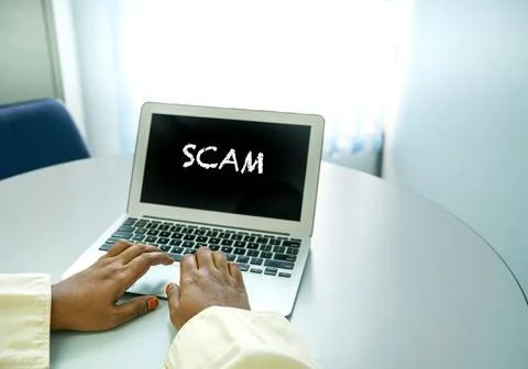 Scam word on computer screen. Stock Photos