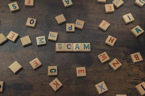 SCAM - a word put together with aligned wooden blocks with letters security and Stock Photos