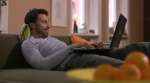 Scandinavian man sitting in a couch using his laptop, Stockholm, Sweden. Stock Footage 51816108