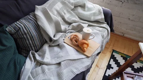 Scandinavian style - comfortable sofa with coffee and croissant Stock Footage 114158125