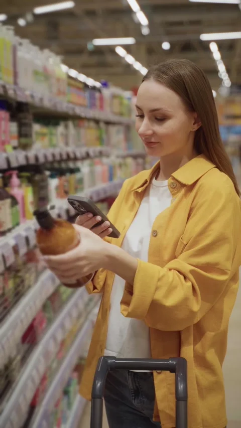 Scanned shower gel selection process in a grocery store during midday shopping Stock Footage 305416353
