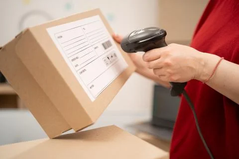 Scanner reading barcode on boxes for logistics, e-commerce. Seller or entrepr Stock Photos
