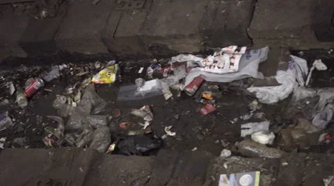 Scanning across dirty trash, garbage on subway tracks in train station, 4K NYC Stock Footage 60790001