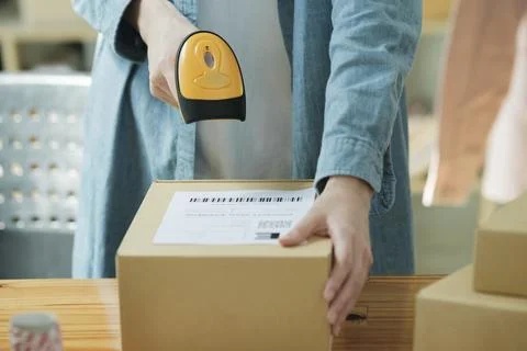 Scanning Barcode on Shipping Box with Scanner Stock Photos