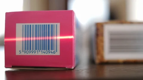 Scanning Barcodes of Multiple Products with Red Laser Barcode Scanner Rack Focus Stock Footage 104618834