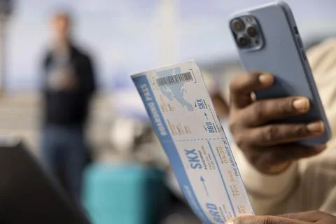 Scanning boarding pass code, close up, black guy with flexible career Foto stock
