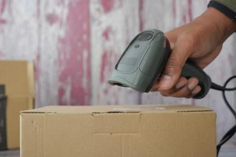 Scanning a box with a barcode scanner at a shipping center Stock Photos