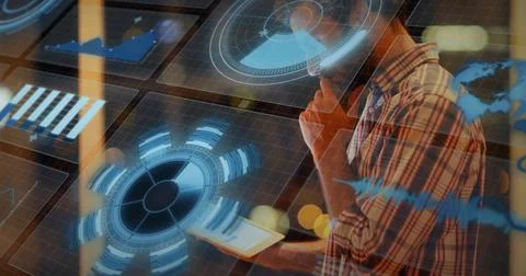 Scanning holographic data male in plaid shirt holding tablet and phone at office Stock Photos