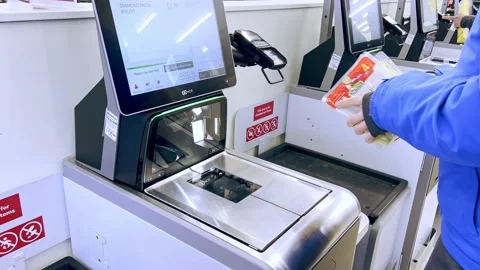 Scanning Items at Self-Checkout in Grocery Store Stock Footage 242386659