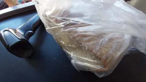 Scanning a loaf of bread at a self-service checkout with a barcode scanner Stock Footage 333644189