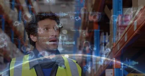Scanning mature warehouse worker studying holograms in aisle, wearing hi-vis Stock Photos