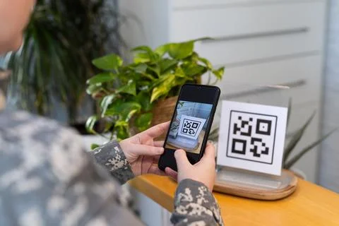 Scanning QR code, person using smartphone in medical clinic environment 写真素材