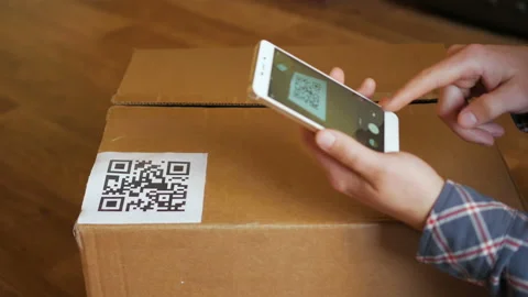 Scanning QR code with smart phone. The man reads the bar code using the appli Stock Footage 88578946