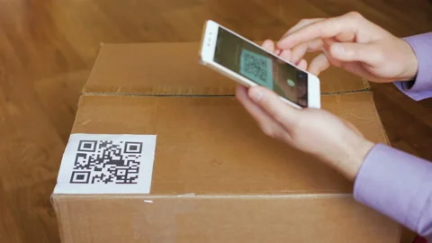 Scanning QR code with smart phone. The man reads the bar code using the appli Stock Footage 88579029