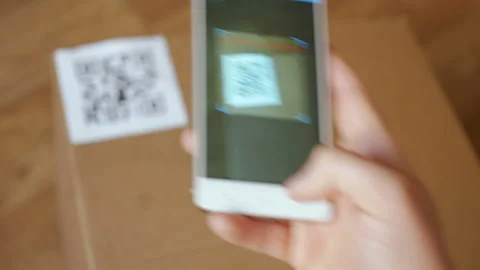 Scanning QR code with smart phone. The man reads the bar code using the appli Stock Footage 88588327