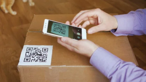 Scanning QR code with smart phone. The man reads the bar code using the appli Stock Footage 88588403
