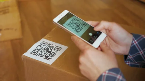 Scanning QR code with smart phone. The man reads the bar code using the appli Stock Footage 95731123