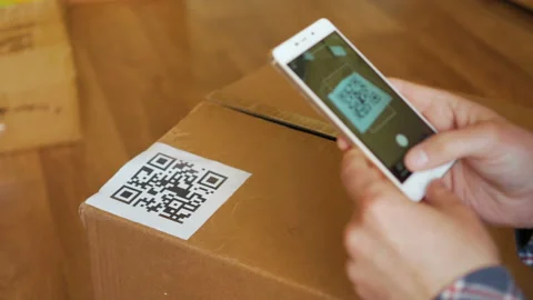 Scanning QR code with smart phone. The man reads the bar code using the appli Stock Footage 95731175