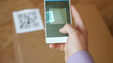 Scanning QR code with smart phone. The man reads the bar code using the appli Stock Footage 95731199