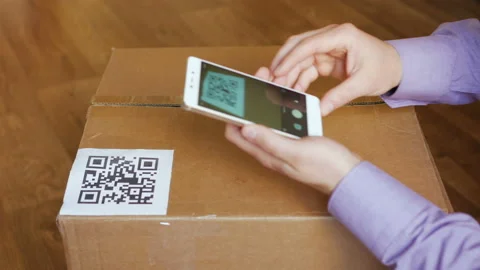 Scanning QR code with smart phone. The man reads the bar code using the appli Stock Footage 95731205