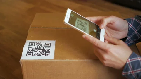 Scanning QR code with smart phone. The man reads the bar code using the appli Stock Footage 100724988