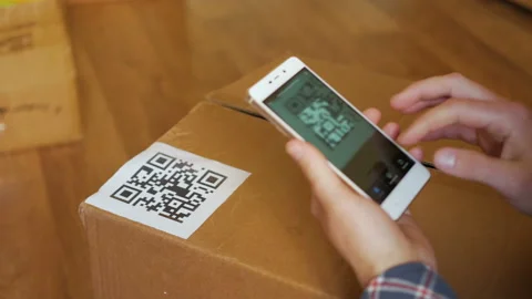 Scanning QR code with smart phone. The man reads the bar code using the appli Stock Footage 105848054
