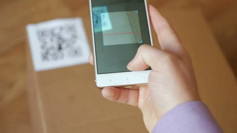 Scanning QR code with smart phone. The man reads the bar code using the appli Stock Footage 105848065