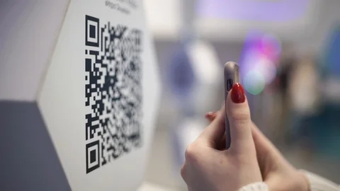 Scanning QR code with smart phone. The man reads the bar code using the Stock Footage 106340986