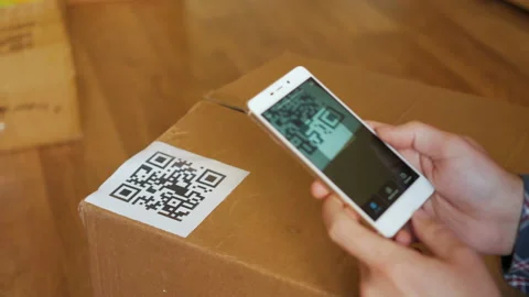 Scanning QR code with smart phone. The man reads the bar code using the appli Stock Footage 115425239