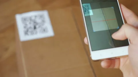 Scanning QR code with smart phone. The man reads the bar code using the appli Stock Footage 118699375