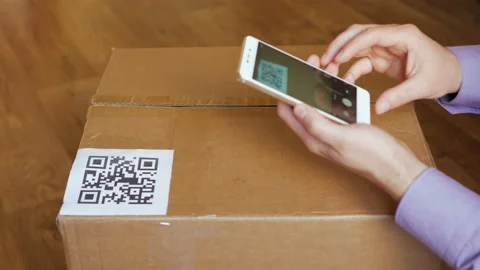 Scanning QR code with smart phone. The man reads the bar code using the appli Stock Footage 118699511