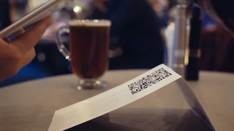 Scanning QR code with smart phone. The man reads the bar code using the Stock Footage 125102213