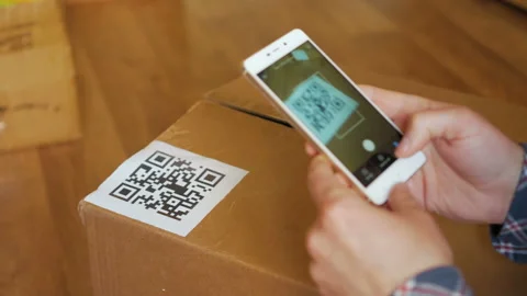 Scanning QR code with smart phone. The man reads the bar code using the appli Stock Footage 125386113