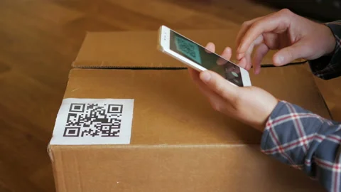 Scanning QR code with smart phone. The man reads the bar code using the appli Stock Footage 125386194