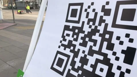 Scanning QR code with smart phone. The man reads the bar code using the Video stock 130651921