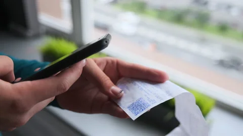 Scanning QR code with smart phone. The woman reads the bar code  Video stock 137603479
