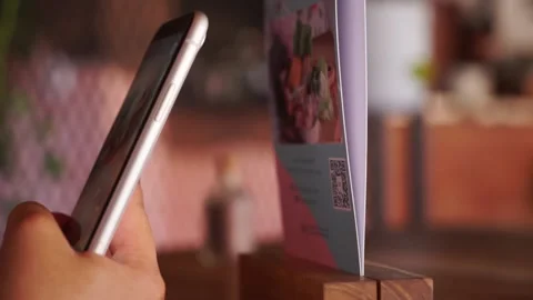 Scanning QR code with smart phone. The woman reads the bar code using the Stock Footage 141948176