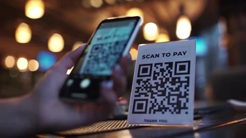 Scanning QR code with smart phone. The woman reads the bar code using the Stock Footage 143280884