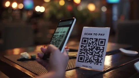 Scanning QR code with smart phone. The woman reads the bar code using the Video stock 143732676