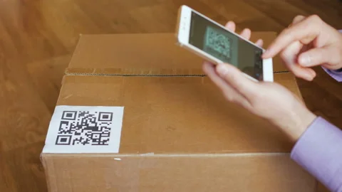 Scanning QR code with smart phone. The man reads the bar code using the appli Stock Footage 147376658