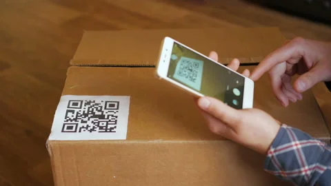 Scanning QR code with smart phone. The man reads the bar code using the appli Stock Footage 163286316