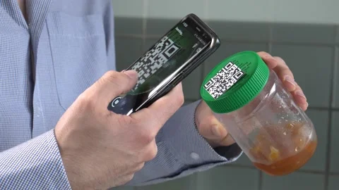 Scanning a QR Code With a Smartphone From a Jar of Jam Stock Footage 140469980
