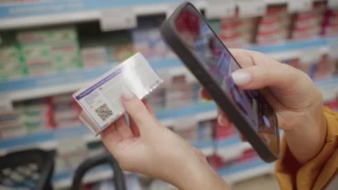 Scanning a QR code on a toothpaste package in a grocery store aisle Stock-Footage 305415332