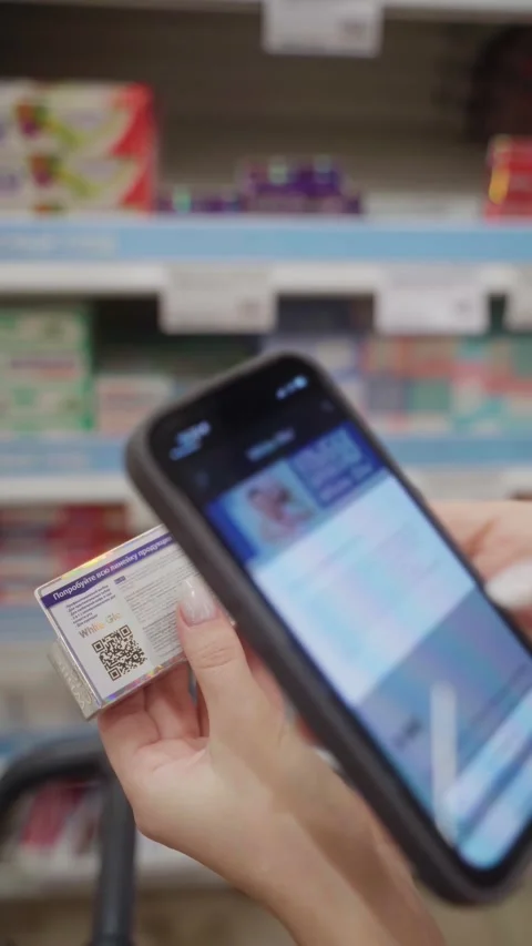 Scanning a QR code of toothpaste in a store aisle for product information Stock Footage 305413985