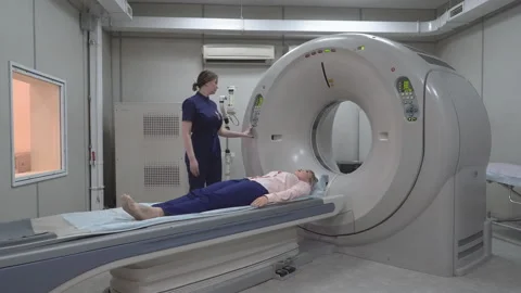 A scanning room with computers and monitors next to the CT scan room in a new Video stock 112861121