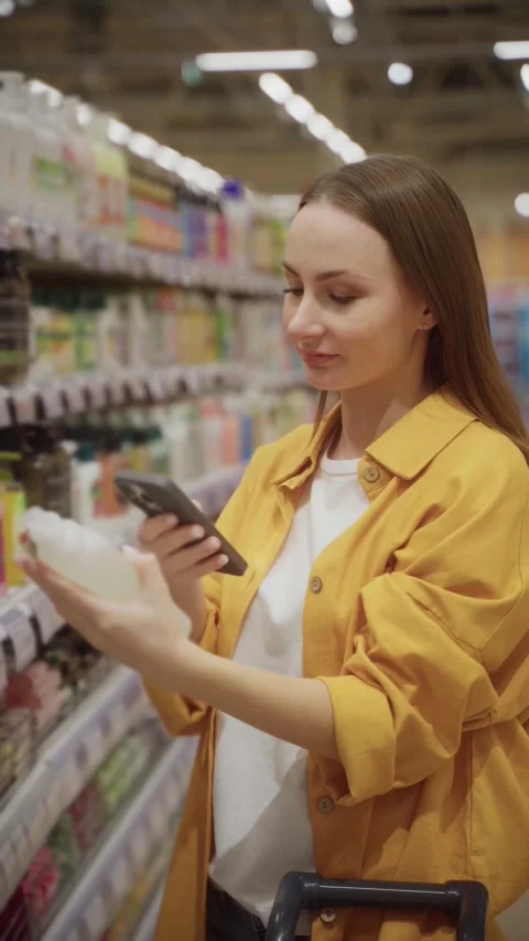 Scanning shower gel products while shopping in a retail store during the day Stock Footage 305416529