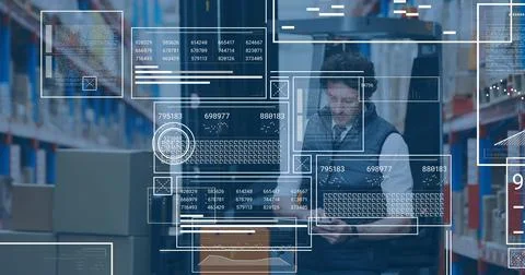 Scanning warehouse worker in vest using tablet and checking inventory at Stock Photos