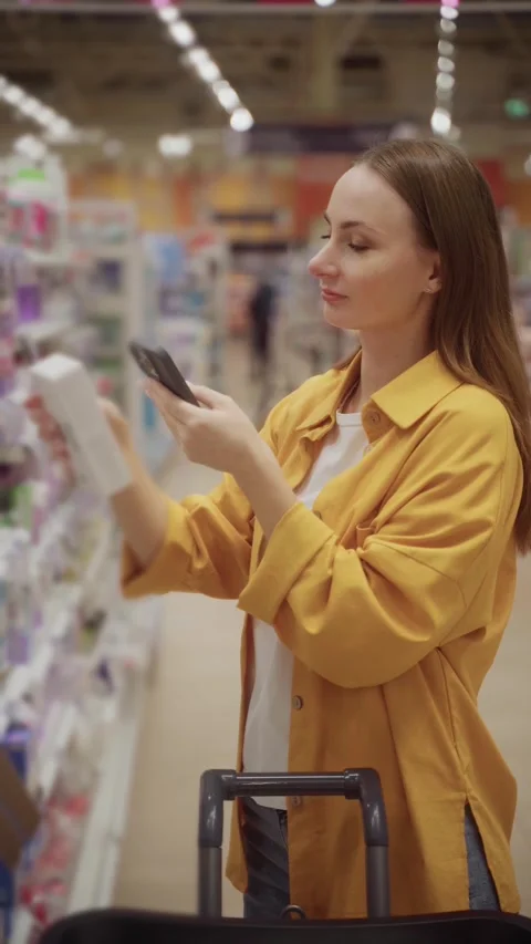 Scanning women's pads in a store while shopping for personal care items Stock-Footage 305416232