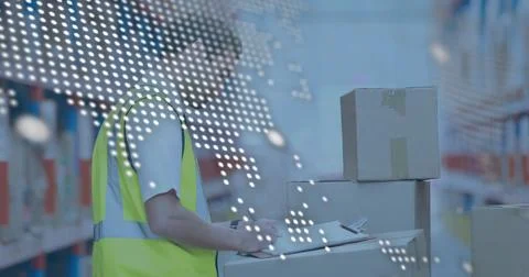 Scanning worker in neon vest checking boxes in warehouse with clipboard and Stock Photos